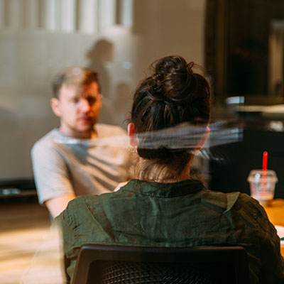 person sitting in a chair in front of a man